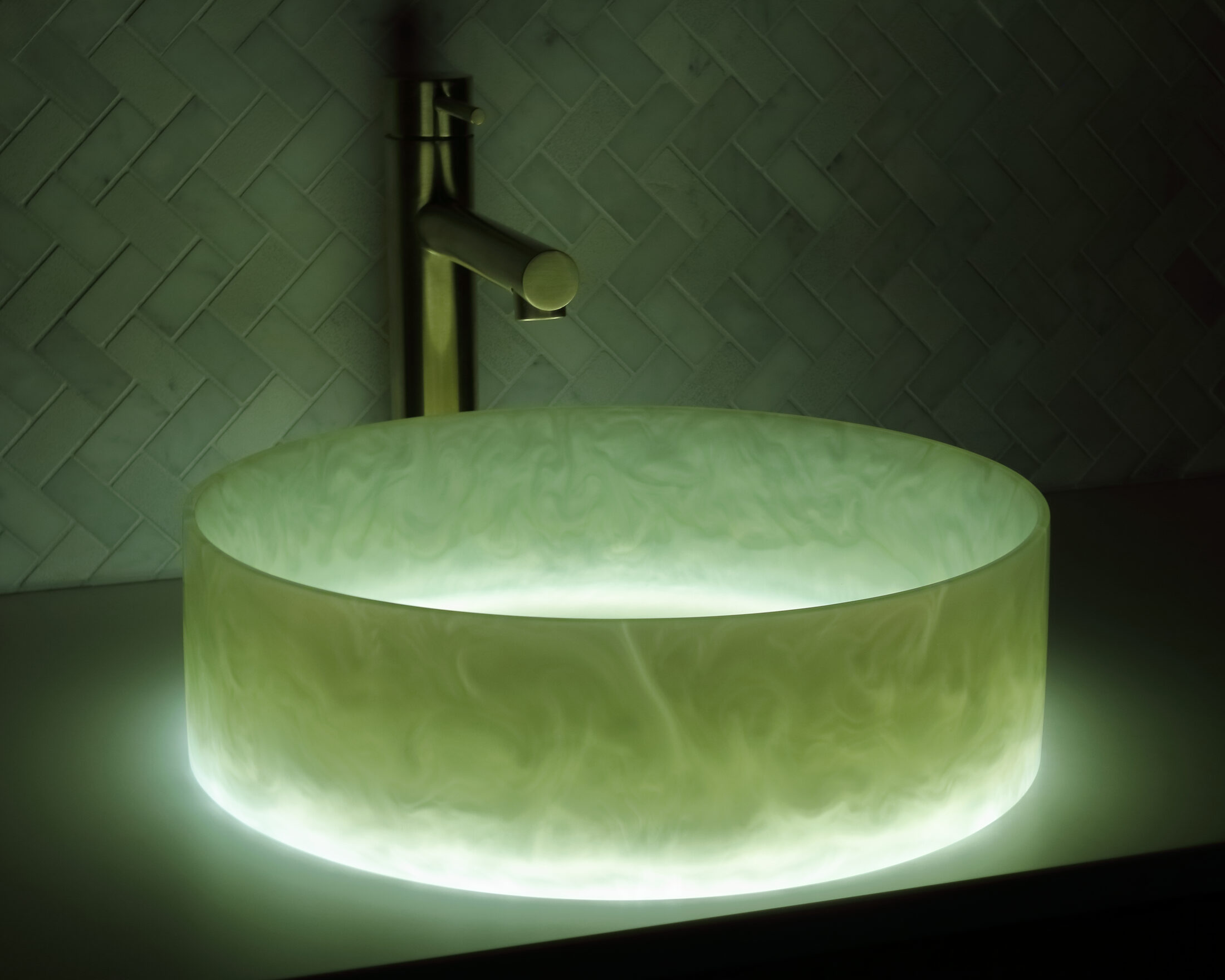 The Basin Lab's seagrass coloured resin basin from their akoya series illuminated by their lightbox