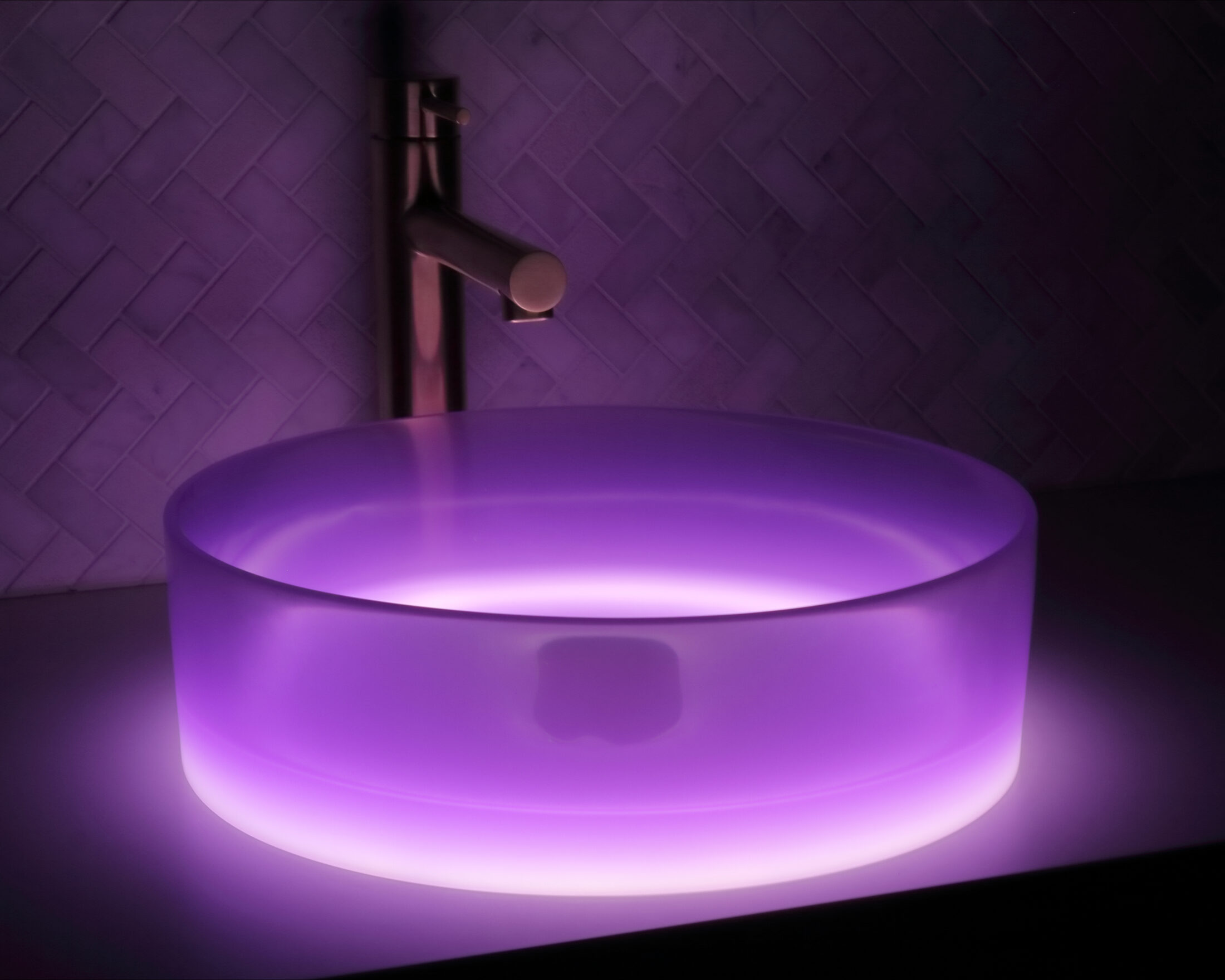 The Basin Lab's purplerain coloured resin basin from their liquid collection illuminated by their lightbox