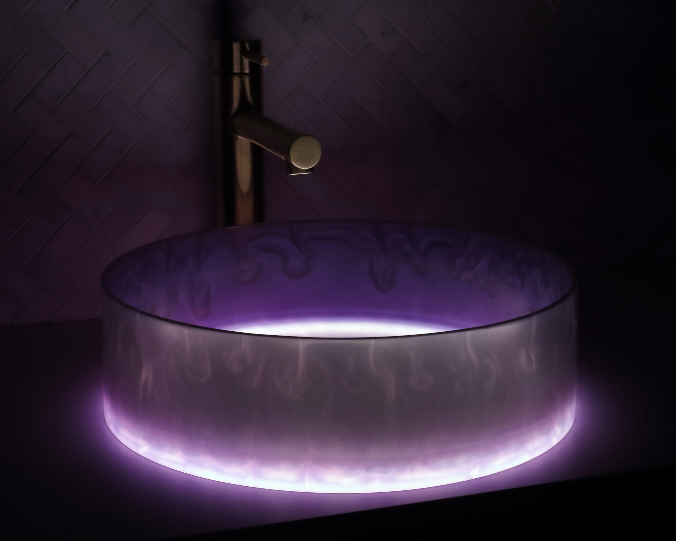 The Basin Lab's amethyst coloured resin basin from their pearl collection illuminated by their lightbox