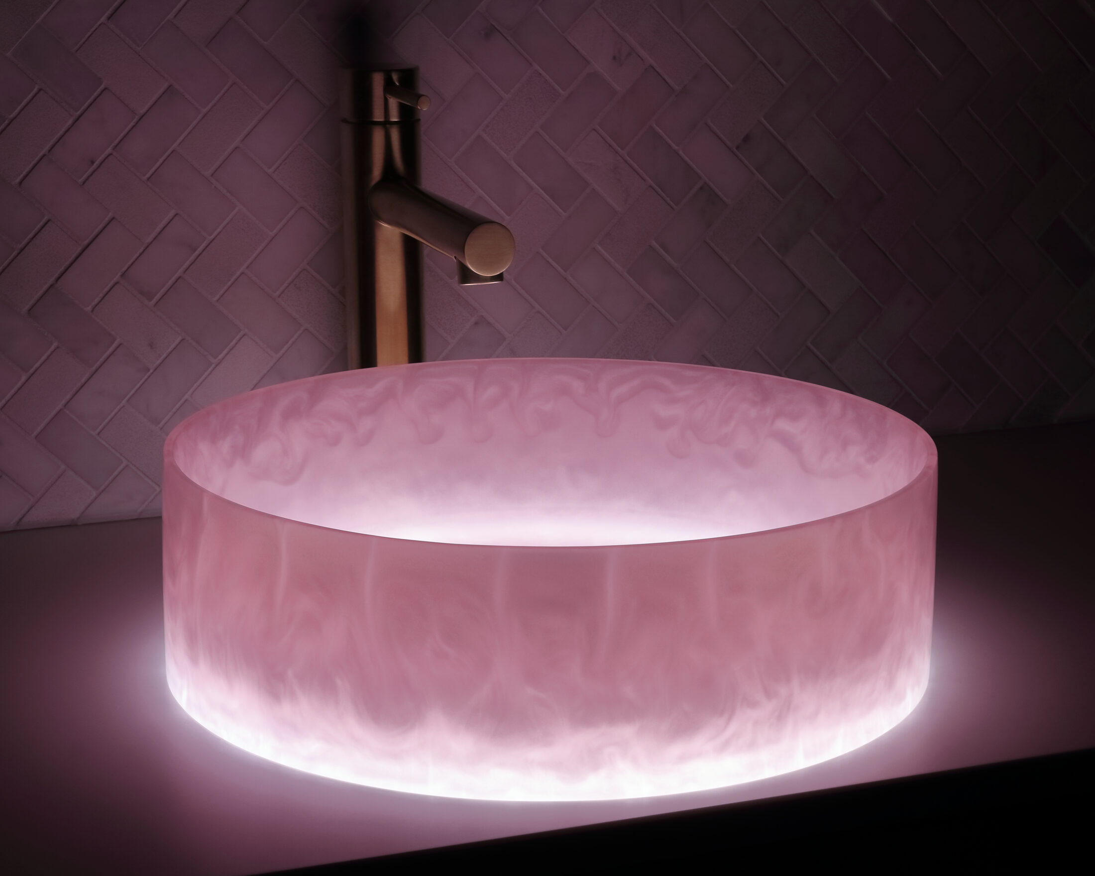 The Basin Lab's barbie coloured resin basin from their pearl collection illuminated by their lightbox