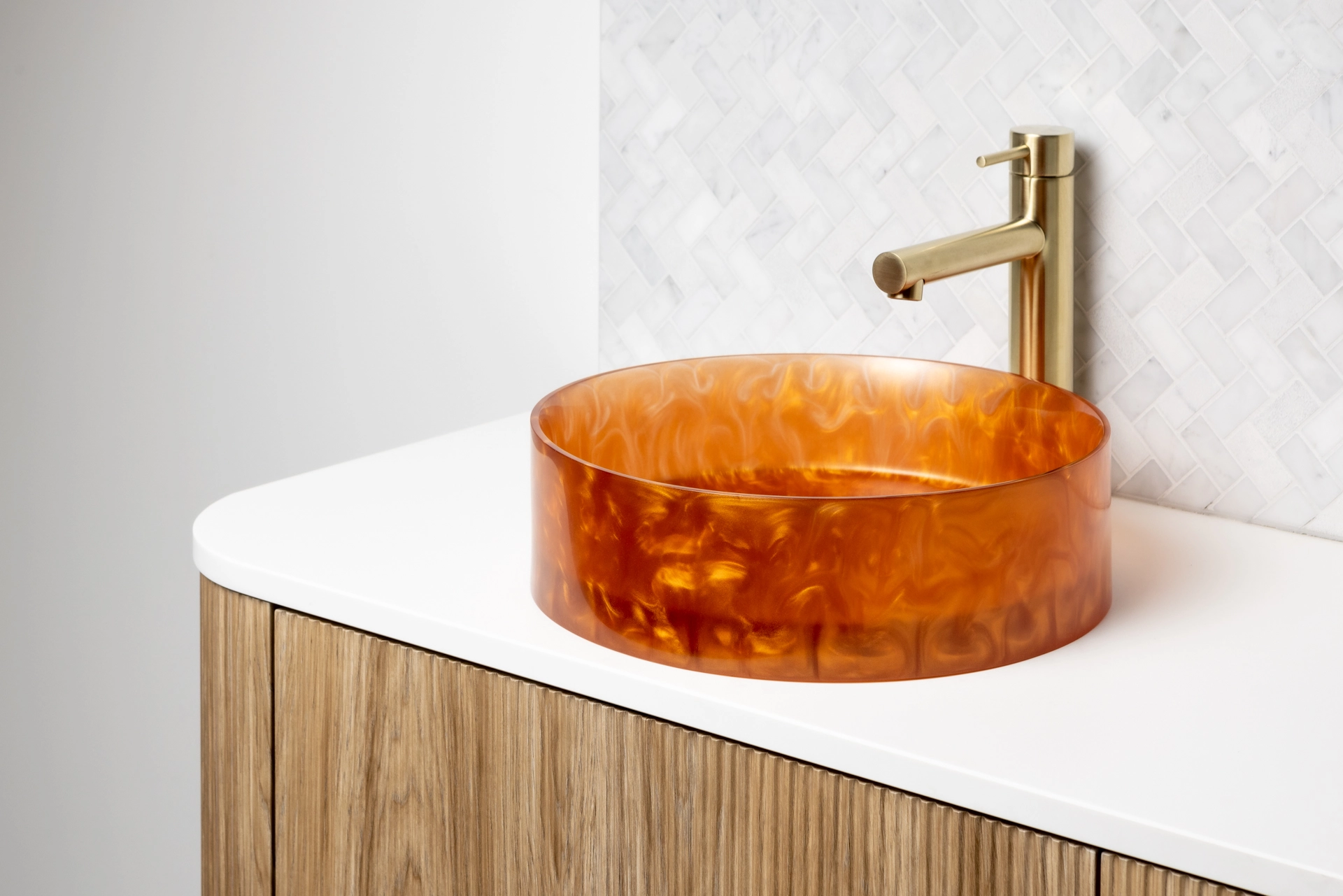 The Basin Lab's Copper coloured basin from their Pearl Collection sitting on a vanity